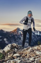 Trail running in autumn on the Jochberg on Lake Walchensee against the wonderful backdrop of the