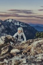 Trail running in autumn on the Jochberg on Lake Walchensee against the wonderful backdrop of the