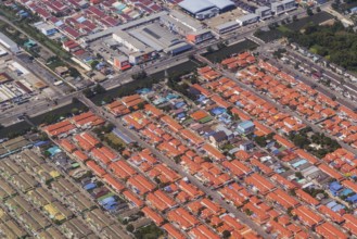 Retort city in the north-east of Bangkok. Standardised houses stand close together on the straight