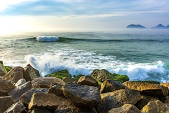 Waves crashing against the breakwater at Barra da Tijuca beach in Rio de Janeiro at dawn Rio de