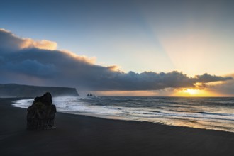 View from Cape Dyrhólaey at sunrise, rock formations Reynisdrangar and the mountain Reynisfjall,