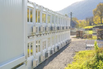 Rows of containers with air coolers in a sunny landscape, Beermiß refugee accommodation centre,