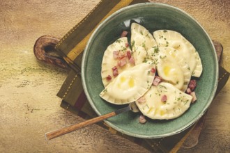 Dumplings, with fried prosciutto, a traditional dish of Polish cuisine, dumplings, top view,