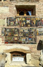 Mosaic of picture tiles on the façade of the historic building of the Rezo Gabriadze puppet