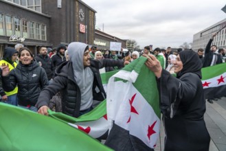 Syrian woman celebrate the end of the Assad regime after the change of power in Syria at a rally on