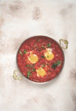 Shakshuka, breakfast, fried eggs in tomato sauce, with spices and herbs, homemade, no people