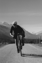 Road bike rider in spring near Halblech in the Allgäu in front of a picturesque backdrop of the