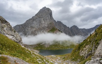 Mountain lake Wolayersee and rocky cloudy mountains, Carnic Alps, Carnic High Trail, Carinthia,