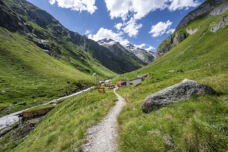 Mountain hut Clarahütte, Umbaltal with mountain stream Isel, glaciated mountain peaks in the