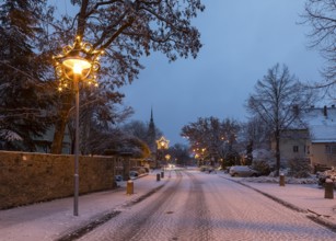 Snow-covered town centre with star tree on Wettinplatz, Coswig, Saxony, Germany, Europe