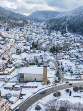 Urban winter landscape with snow-covered houses and church, Calmbach, Black Forest, Germany, Europe