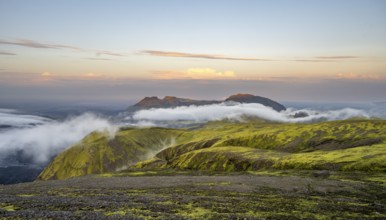 Fog between mountains, moss-covered volcanic mountain landscape, at sunset, Pakgil, Iceland, Europe