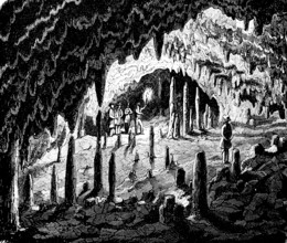 Visitors in a stalactite cave in Westphalia, stalactites, stalagmites, torch, light, history of