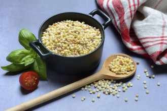 Fregola in pots and spoons, uncooked, pasta variety from Sardinia, Italy, Europe