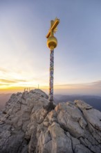 Golden summit cross on the summit of the Zugspitze at sunset, Wetterstein Mountains, Bavaria,