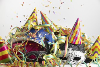 Colourful party hats with confetti and streamers in a lively party setting, carnival