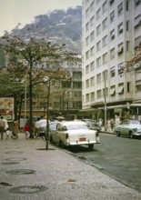 Streets, shops, parked cars in Copacabana, Rio de Janeiro, Brazil 1962 Shantytown Favela on a