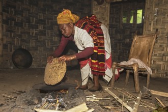 Woman from the Dorze ethnic group with a freshly baked Kotcho flatbread made from plant parts of