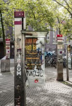 Old, no longer functional public telephones, of Telekom, destroyed, dirty, at the main railway