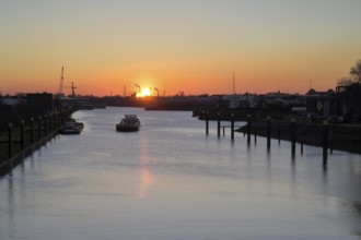 Ships on the Rhine-Herne Canal, Duisburg lock, at sunset, Duisburg, Ruhr area, North