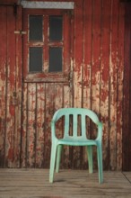 Plastic chair, old fishermen's huts in Armacao de Pera, Algarve, Portugal, Europe