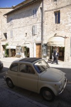 Fiat 500 in a street in the historic centre of Assisi, Umbria, Italy, Europe