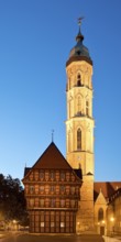 Old scales, detailed reconstruction with the illuminated St Andrew's Church in the evening,