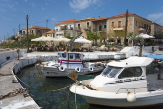 Harbour with fishing boats and Mediterranean buildings in the background. Sunny day with