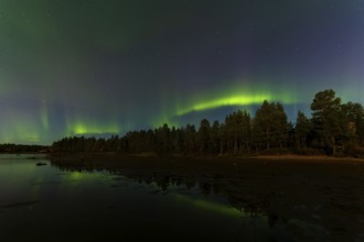 Northern lights, (Aurora borealis) at a lake near Kiruna, September 2024, Lapland, Sweden, Europe