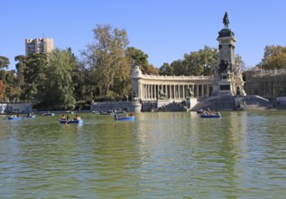 Rowing boats in boating pond of Estanque, El Retiro park, Madrid, Spain, monument to King Alfonso