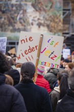 Close-up of a sign with the inscription never again in a demonstration, demonstration against the