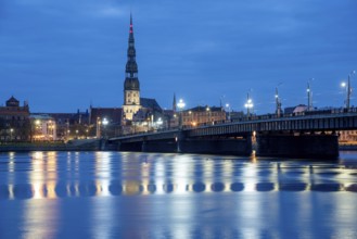 St Peter's Church and stone bridge in the morning at the blue hour, River Daugava, Riga, Latvia,