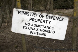 Ministry of Defence property sign No admittance to unauthorised persons on fence, Bawdsey, Suffolk,