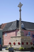 War memorial and historic buildings in the town of Holt, north Norfolk, England, United Kingdom,