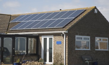 Solar panels on bungalow roof, Walton on the Naze, Essex, UK