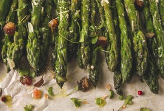 Grilled asparagus, with spices and herbs, parmesan cheese, on a white background, top view, rustic,