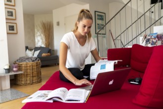 Young student learns at home, online, on her notebook