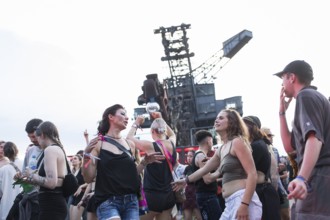 Celebrating visitors in front of excavators at the Melt Festival in Ferropolis on 12 July 2024.