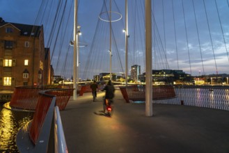 Cyclists on the Cirkelbroen cycle and pedestrian bridge, over the harbour, in the Christianshavens