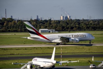 Düsseldorf Airport, Emirates Airbus A380-800 taking off, in the background the HKM steelworks in