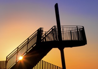 Viewing platform of the Pluto spoil tip at atmospheric sunset, Herne, Ruhr area, North