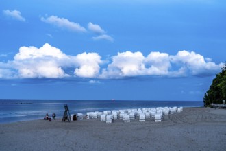 Beach in the evening, with thick storm clouds, near Sellin, beach chairs, island of Rügen,