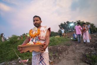 Devotees carries the Ganesha idol to immerse in the Brahmaputra river, during Ganesh Chaturthi