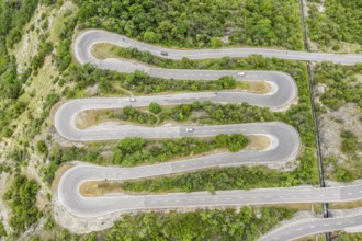 Aerial view, drone shot, Mountain pass road with multiple hairpins, water pipeline, Switzerland,