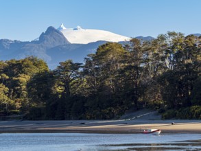 Beach at Puerto Raul Marin Balmaceda, snowcovered volcano Corcovado in the back, Patagonia, Chile,