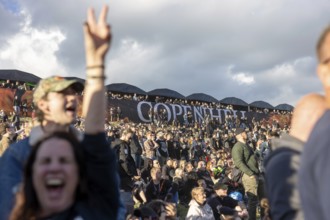 Copenhagen, Denmark - 19 June 2024: Festivalgoers in front of the logo at the Copenhell Metal