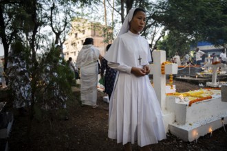 Nuns offer prayers on the grave during the All souls day observation, in Guwahati, India on 2