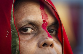 Hindu devotees perform rituals as they offer prayers to the Sun god in the bank of Brahmaputra