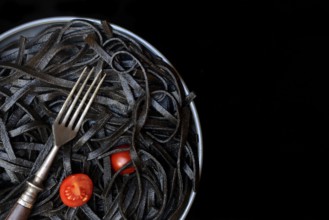 Black pasta coloured with squid ink and fork, Taglioni al Nero di Seppia, Italy, Europe