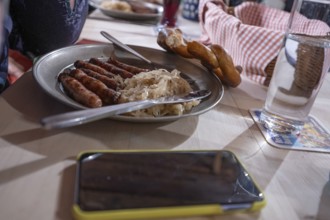 Nuremberg sausages with sauerkraut served on a pewter plate, Nuremberg, Middle Franconia, Bavaria,